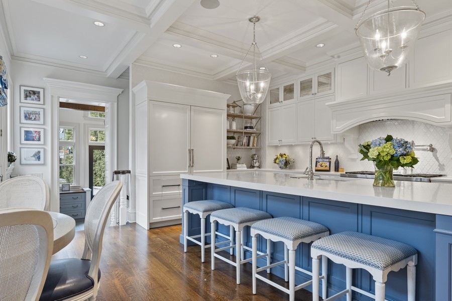660 Prospect Avenue Winnetka, IL 60093 - Photo 20 of 77 a view of a dining room with furniture a chandelier and wooden floor