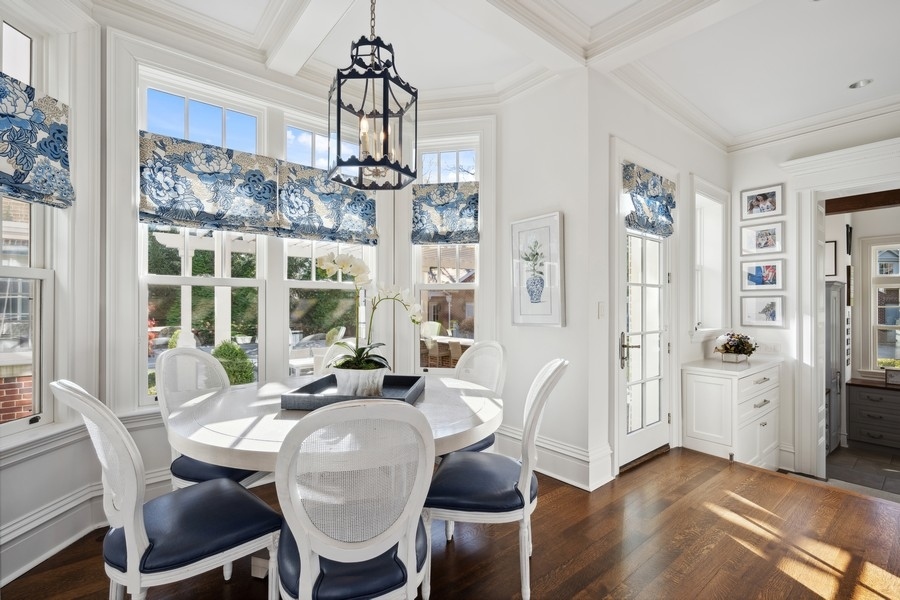 660 Prospect Avenue Winnetka, IL 60093 - Photo 23 of 77 a view of a dining room with furniture large windows and wooden floor