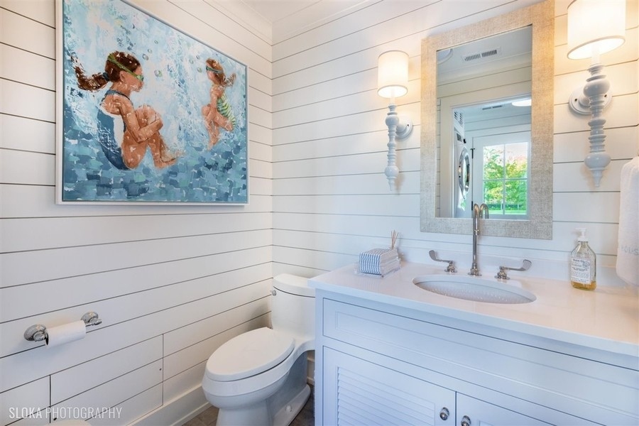 660 Prospect Avenue Winnetka, IL 60093 - Photo 30 of 77 a bathroom with a toilet sink and mirror