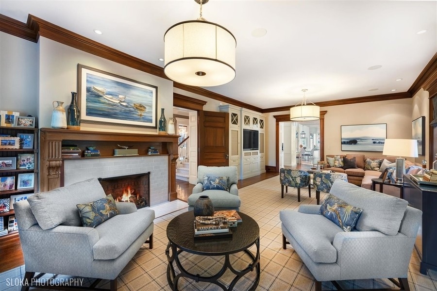 660 Prospect Avenue Winnetka, IL 60093 - Photo 36 of 77 a living room with furniture a fireplace and a large window