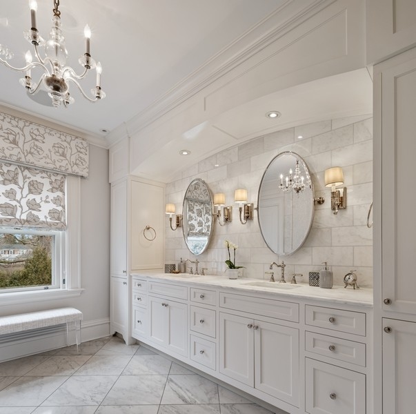 660 Prospect Avenue Winnetka, IL 60093 - Photo 47 of 77 a spacious bathroom with a double vanity sink and a mirror