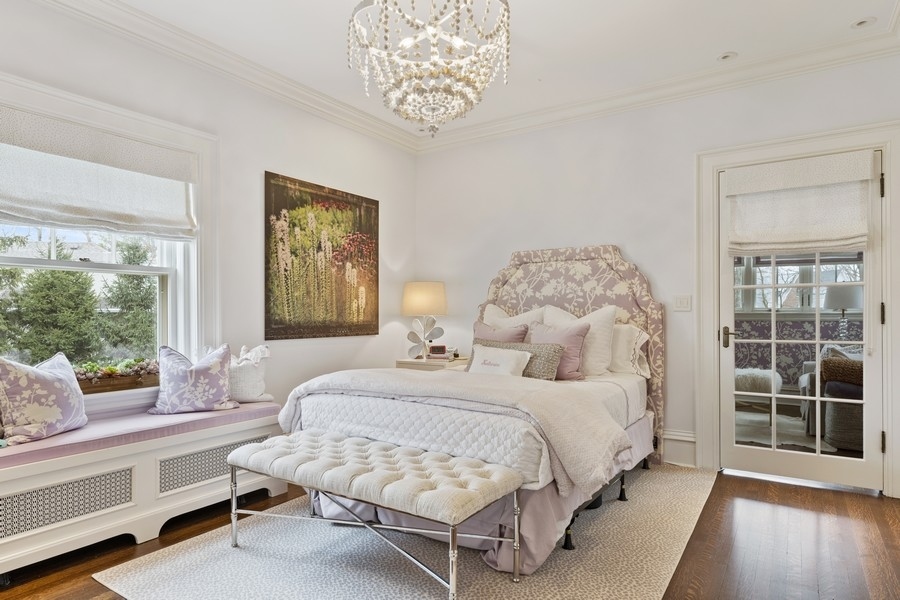 660 Prospect Avenue Winnetka, IL 60093 - Photo 52 of 77 a bedroom with a large bed and a window