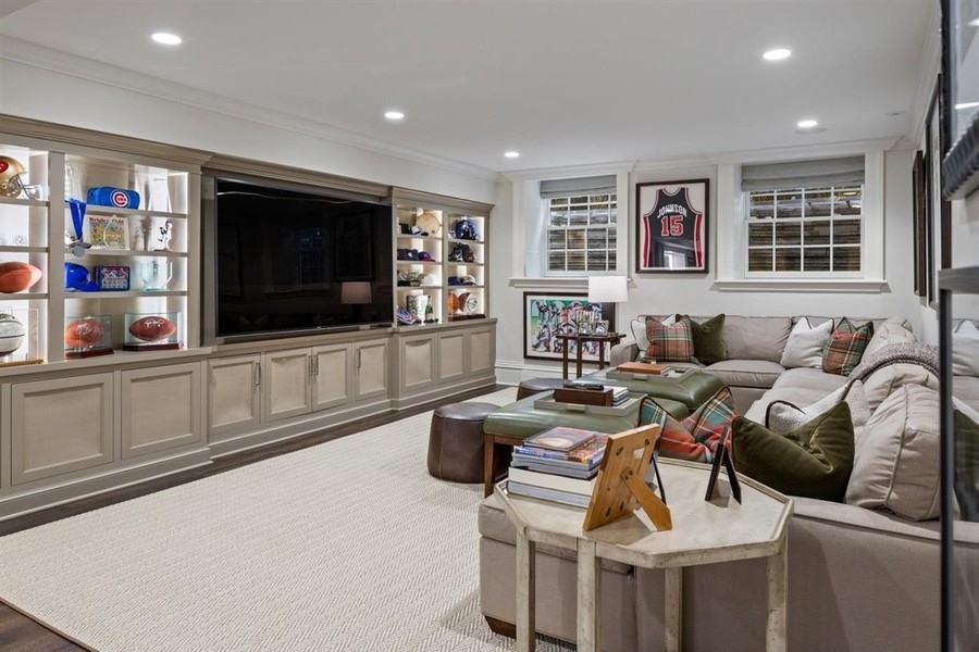 660 Prospect Avenue Winnetka, IL 60093 - Photo 66 of 77 a living room with furniture a flat screen tv and a bookshelf