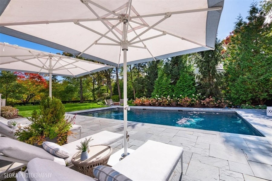 660 Prospect Avenue Winnetka, IL 60093 - Photo 70 of 77 a view of a patio with a table and chairs under an umbrella