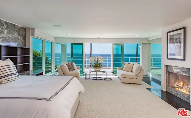 a living room with furniture floor to ceiling window and floor to ceiling window