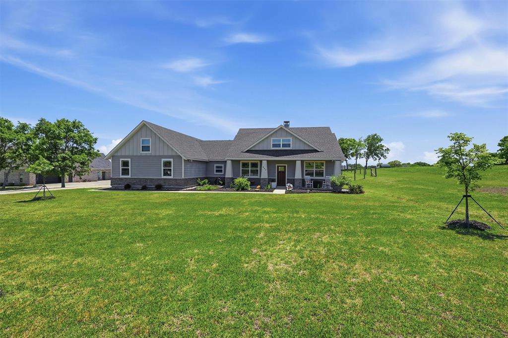 662 Preakness Place Road Van Alstyne, TX 75495 - Photo 1 of 39 a front view of a house with a garden