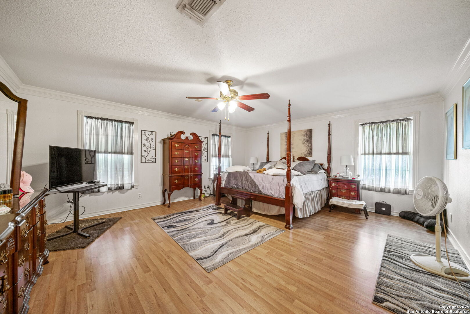 210 Tolle Road Cibolo, TX 78108 - Photo 20 of 61 a spacious bedroom with a bed and a flat screen tv