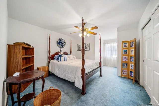 a bedroom with bed and a chandelier