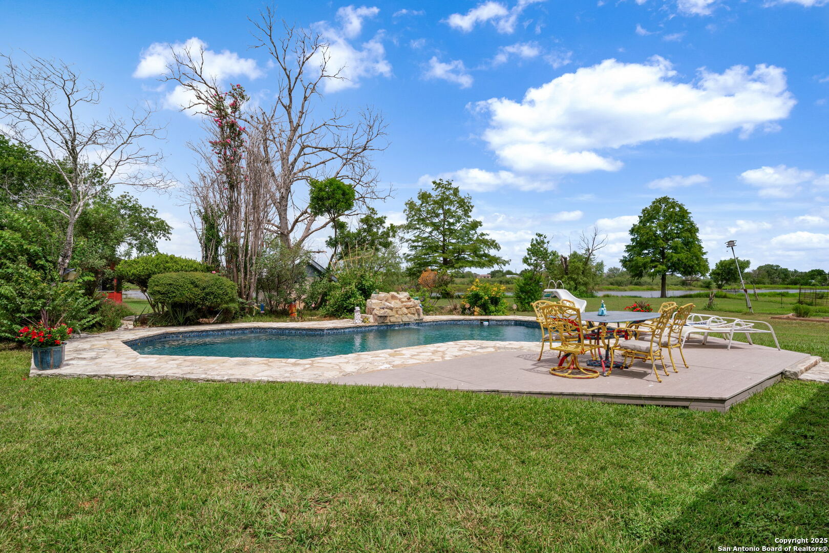 210 Tolle Road Cibolo, TX 78108 - Photo 32 of 61 a view of a swimming pool with a table and chairs