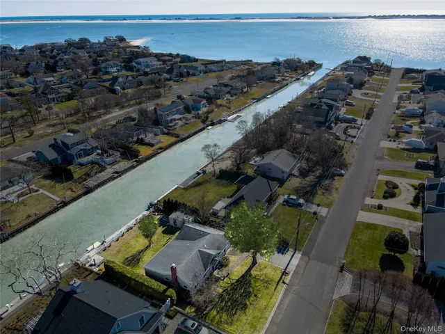 an aerial view of multiple houses with yard