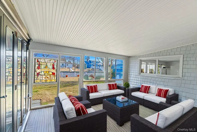 a living room with furniture and a floor to ceiling window