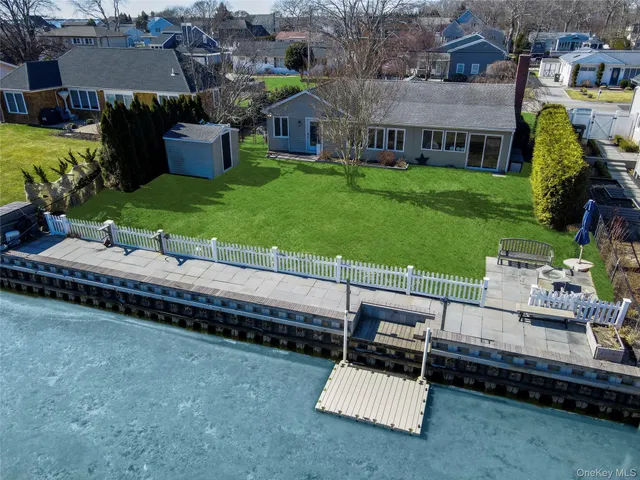 an aerial view of a house with pool garden and a yard