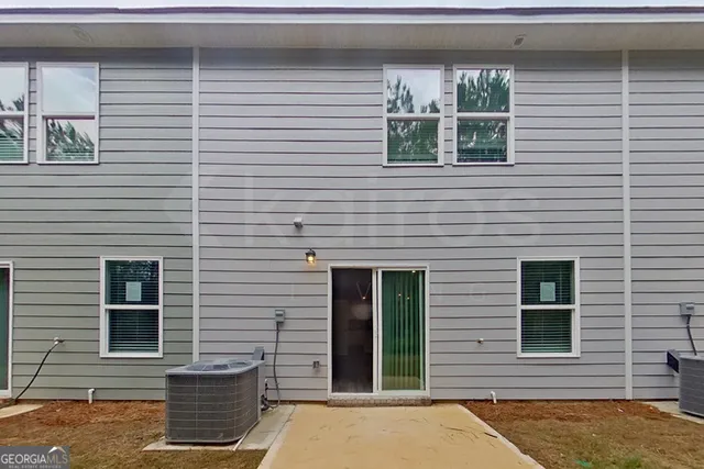 a view of a brick house with many windows