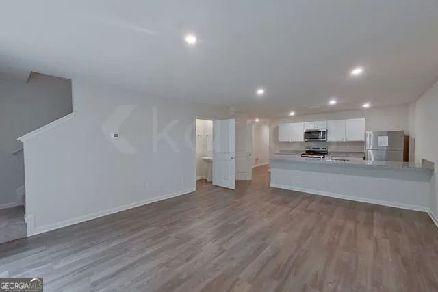 a view of kitchen with kitchen island wooden floor and center island