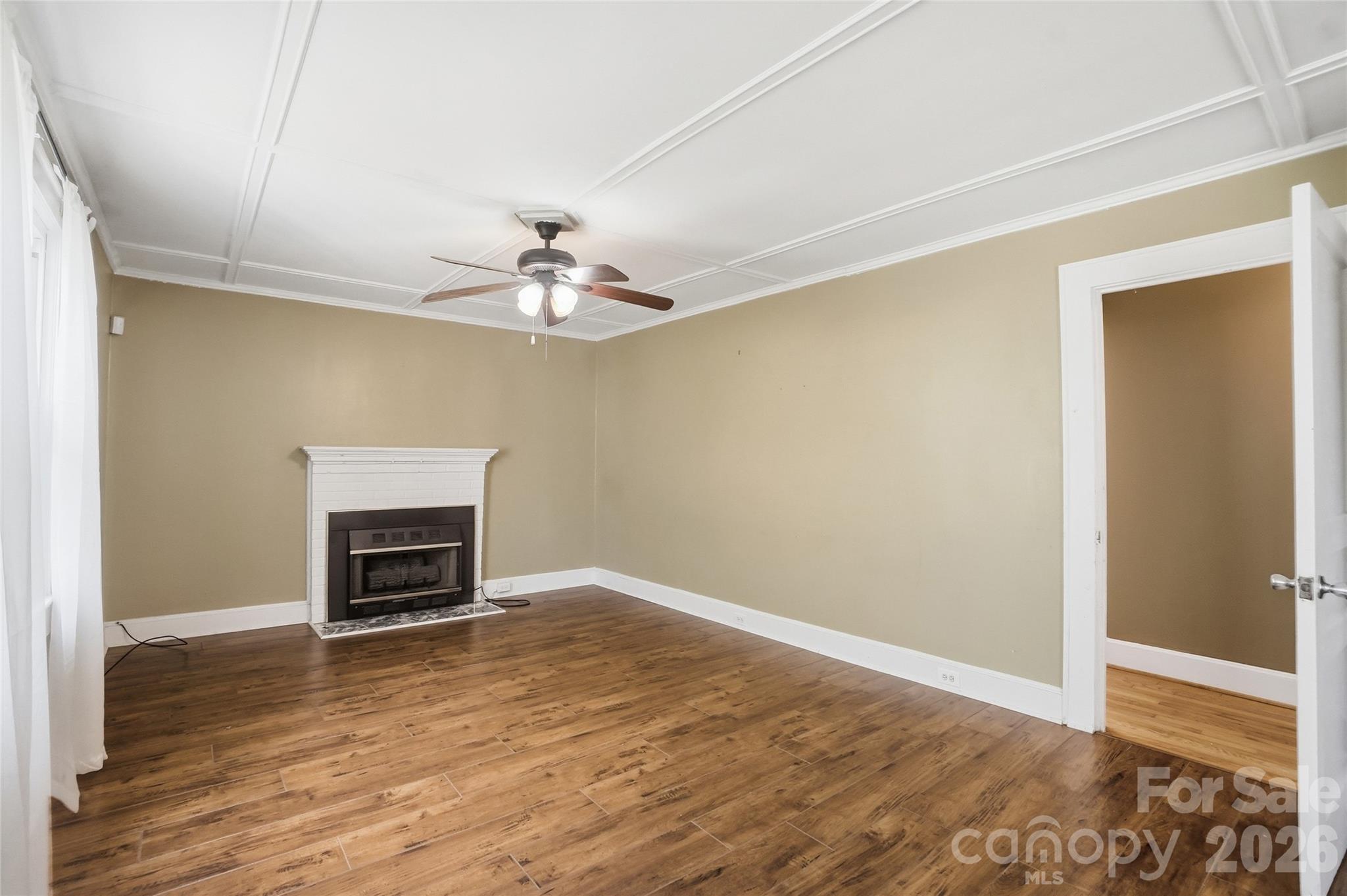 208 Jackson Terrace Clover, SC 29710 - Photo 12 of 30 an empty room with wooden floor chandelier fan and windows