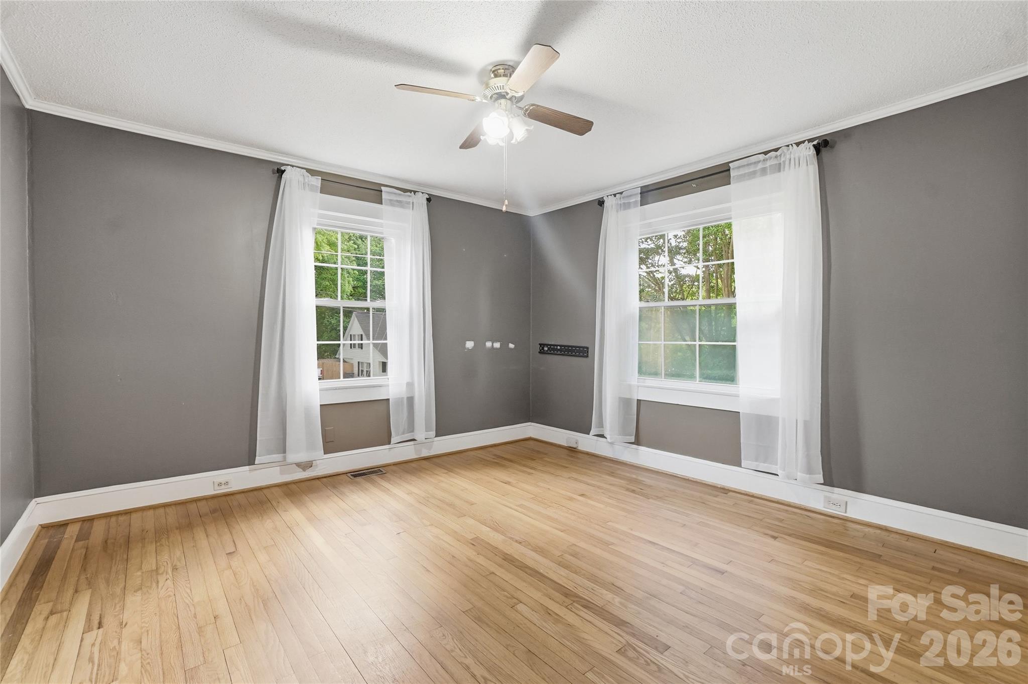 208 Jackson Terrace Clover, SC 29710 - Photo 19 of 30 a view of an empty room with a window and wooden floor
