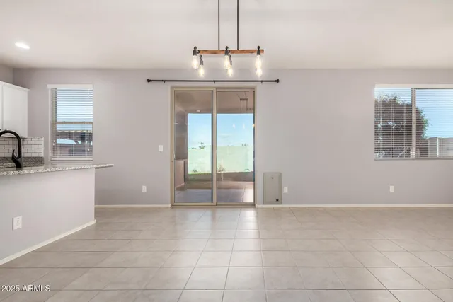 a view of a kitchen with furniture and stainless steel appliances