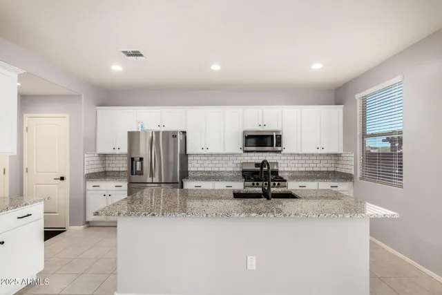 a view of a kitchen with furniture and wooden floor