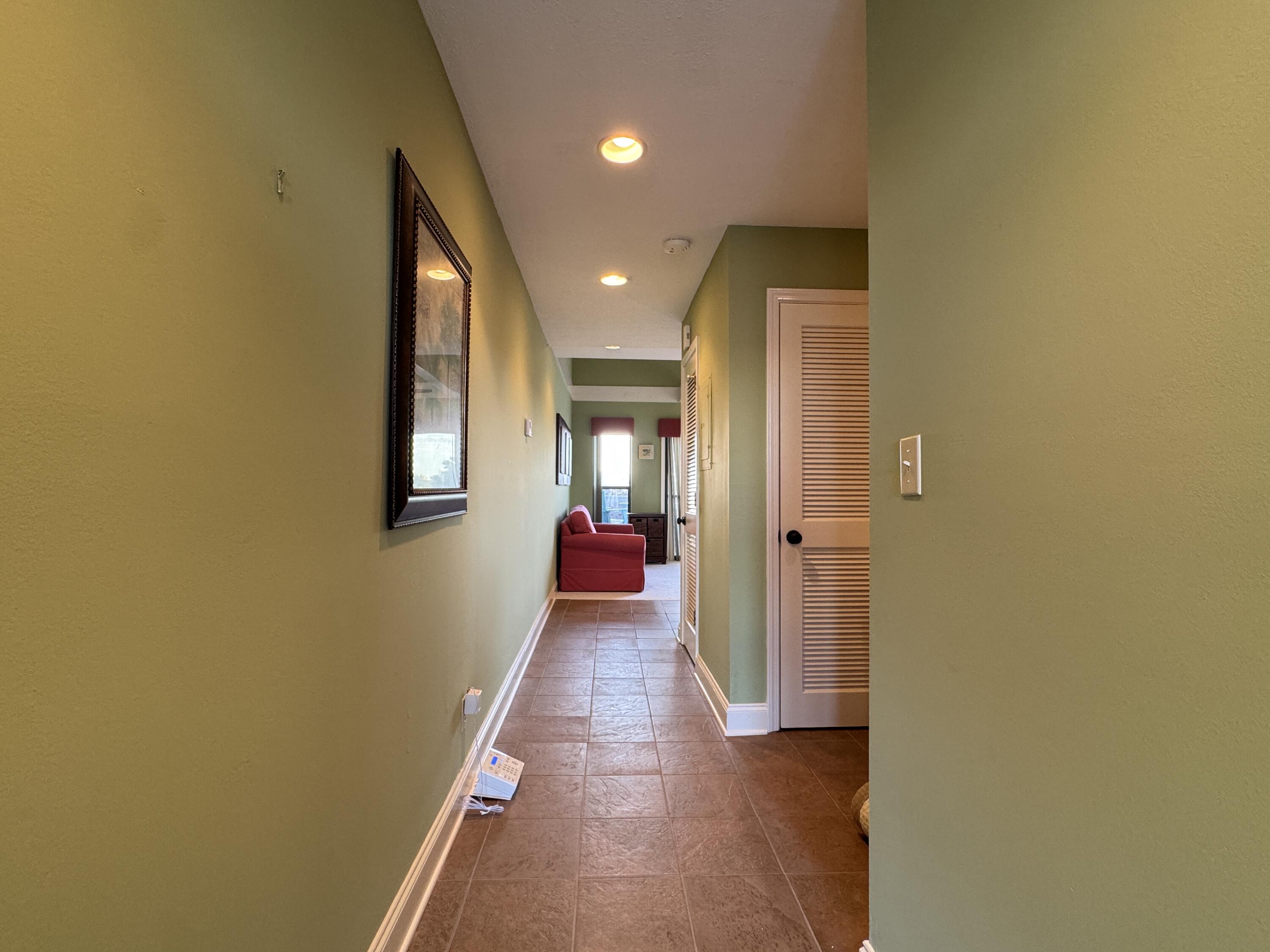 17614 Front Beach Road, Unit C13 Panama City Beach, FL 32413 - Photo 2 of 16 a view of a hallway with wooden floor
