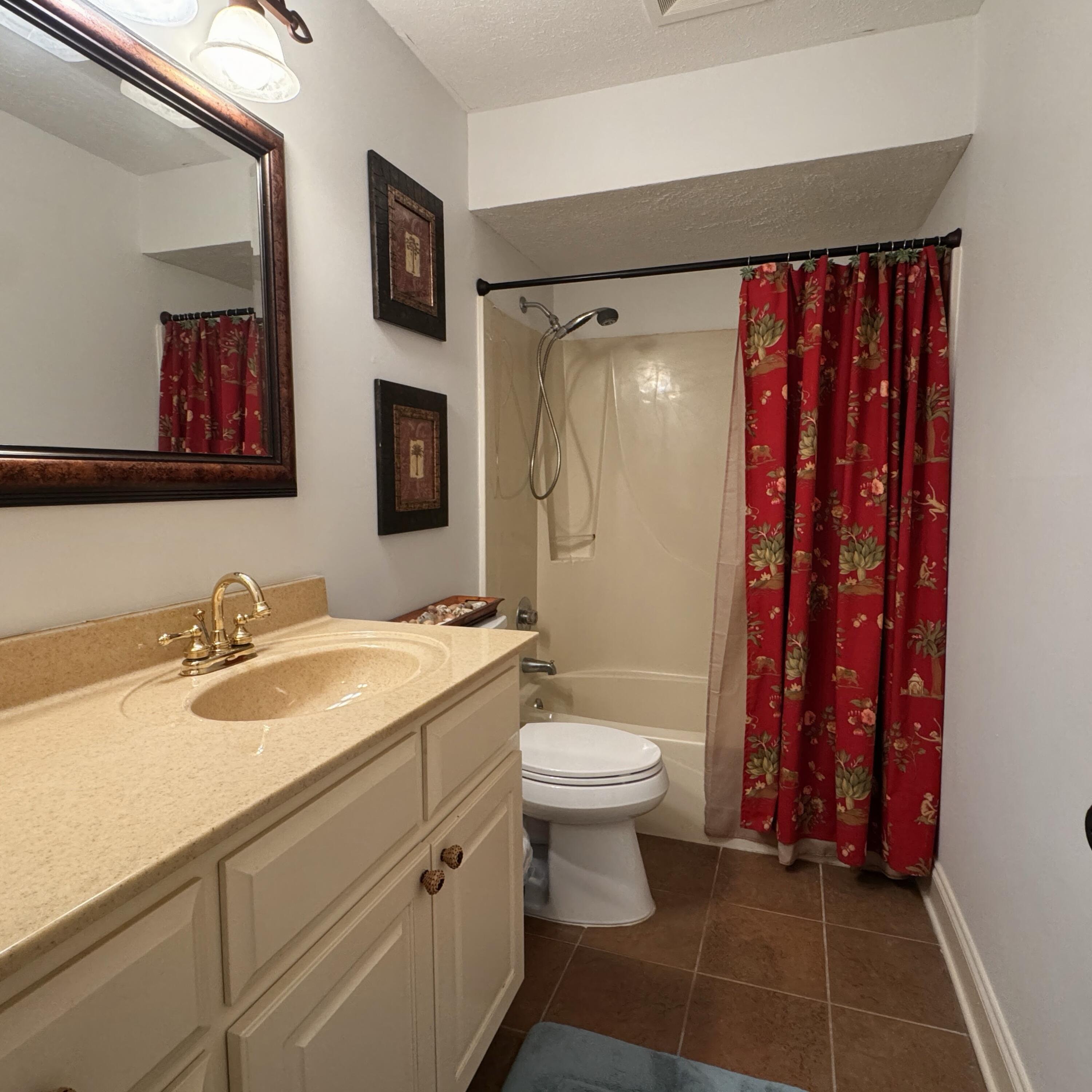 17614 Front Beach Road, Unit C13 Panama City Beach, FL 32413 - Photo 7 of 16 a bathroom with a sink toilet and shower