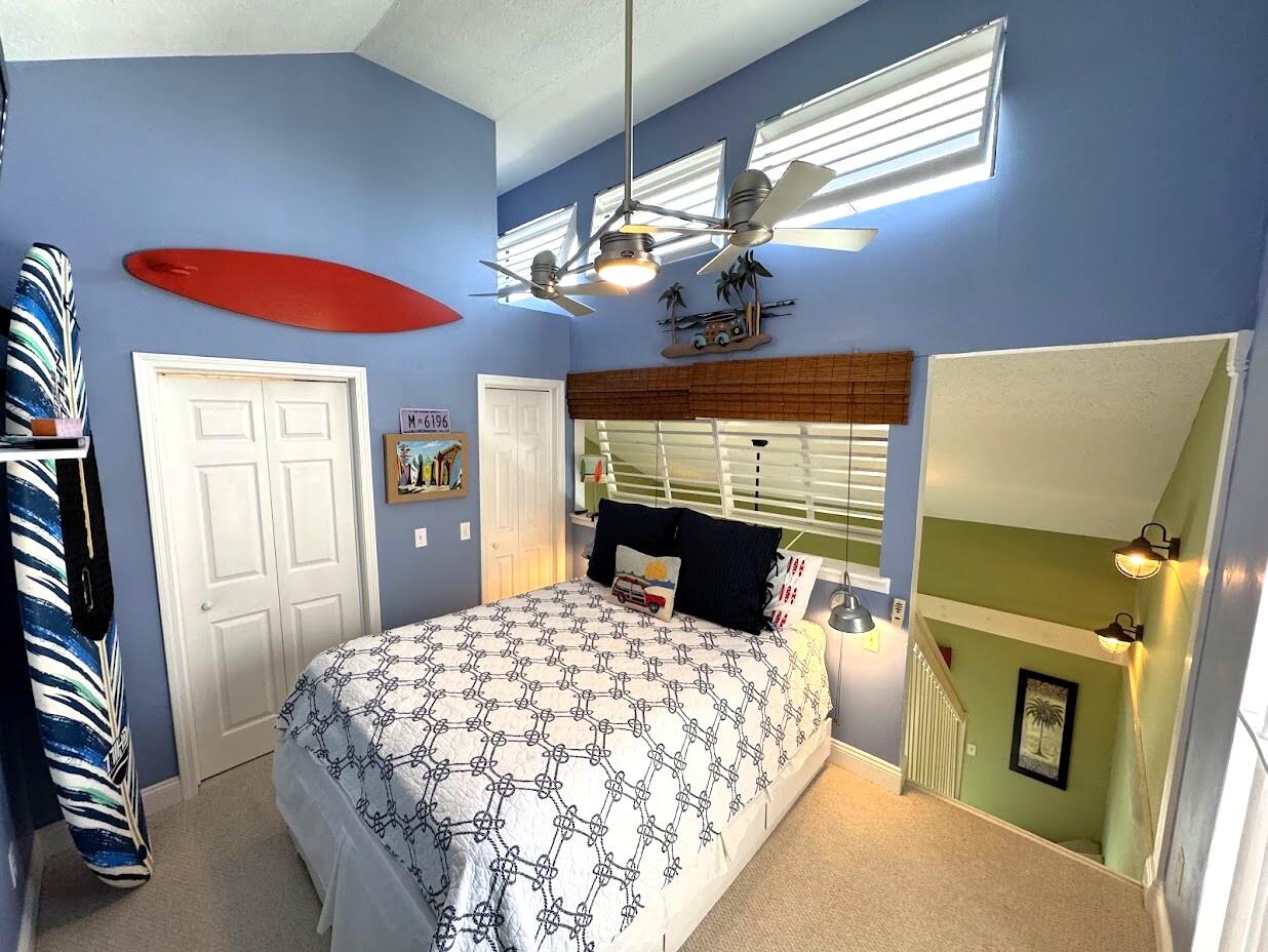 17614 Front Beach Road, Unit C13 Panama City Beach, FL 32413 - Photo 9 of 16 a bedroom with a bed and a fireplace