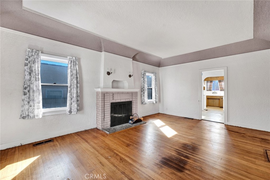 637 East Fairmount Road Burbank, CA 91501 - Photo 2 of 25 a view of an empty room with wooden floor fireplace and a window