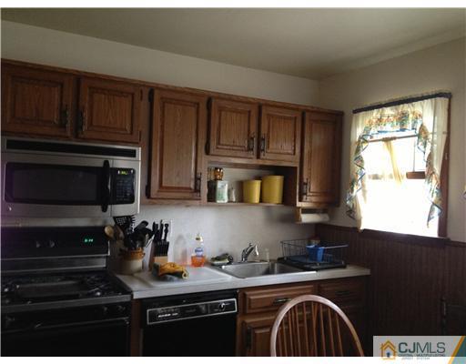 9 Clemson Road Old Bridge, NJ 08859 - Photo 3 of 10 a kitchen with granite countertop a stove sink and cabinets