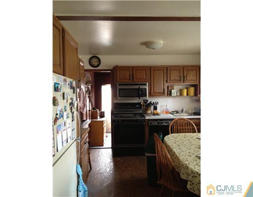 9 Clemson Road Old Bridge, NJ 08859 - Photo 5 of 10 a kitchen with granite countertop stainless steel appliances and wooden cabinets