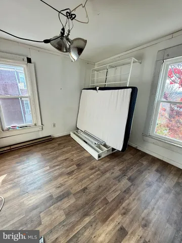 a view of a room with wooden floor and window