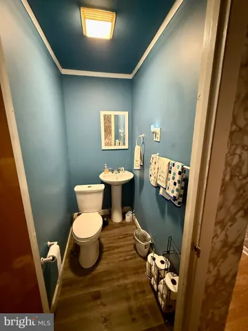 a bathroom with a toilet and a mirror