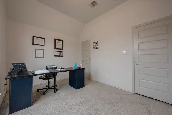 a view of a workspace with furniture
