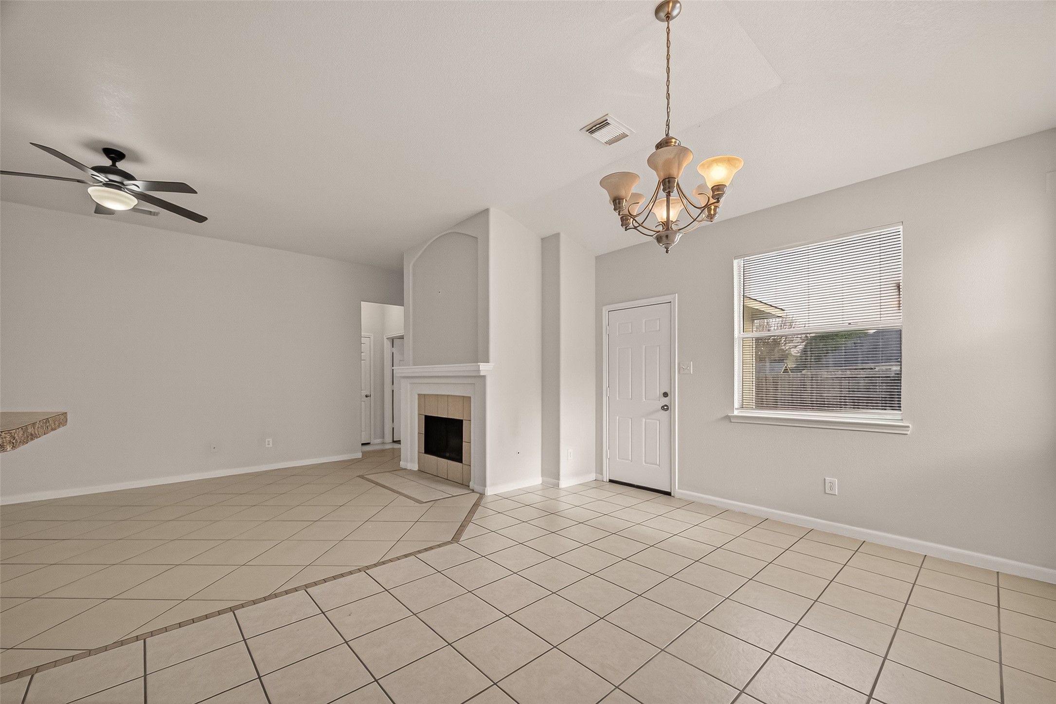 1918 Riane Lane Houston, TX 77049 - Photo 11 of 35 a view of a livingroom with a chandelier fan and windows