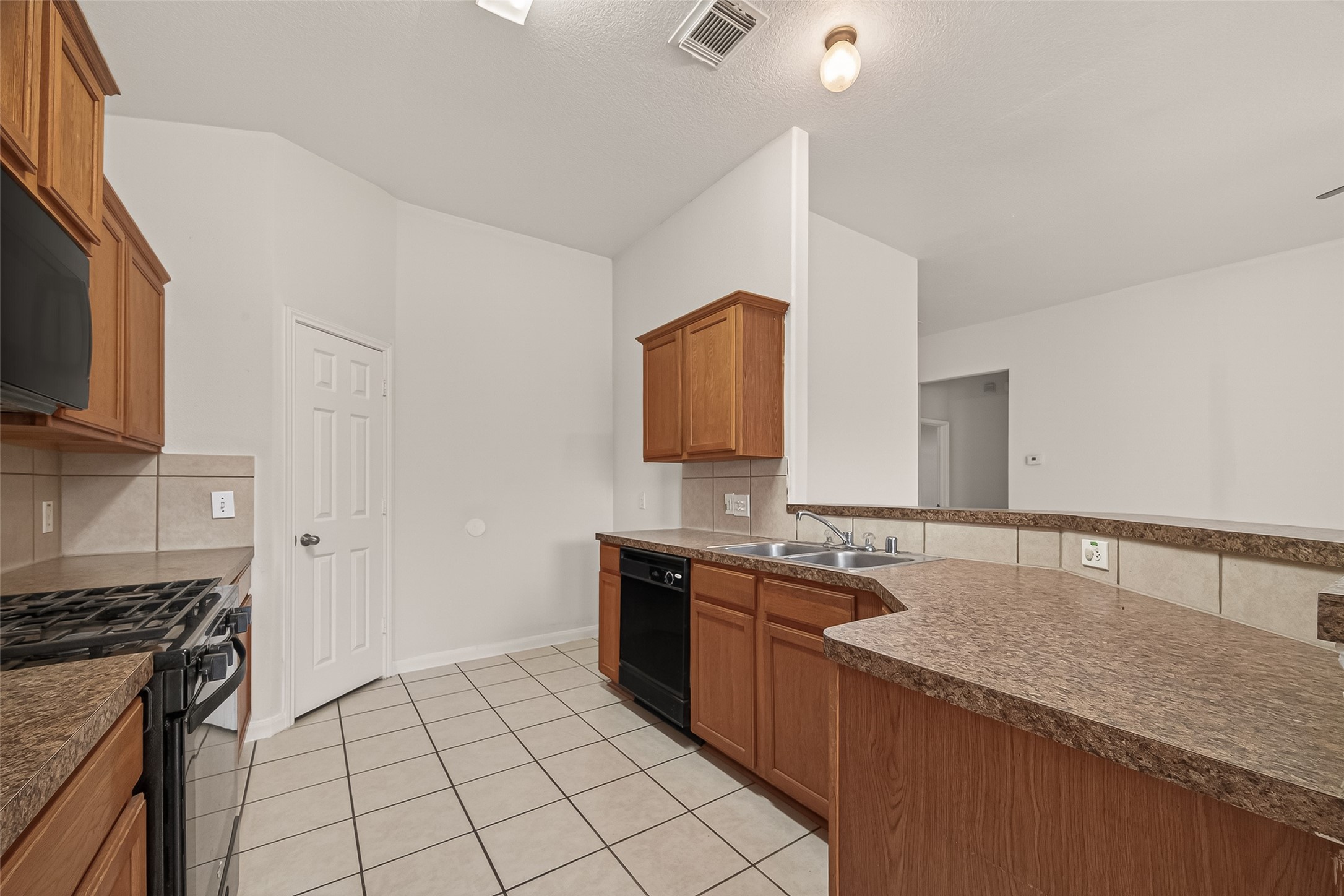 1918 Riane Lane Houston, TX 77049 - Photo 12 of 35 a kitchen with a sink and a stove top oven