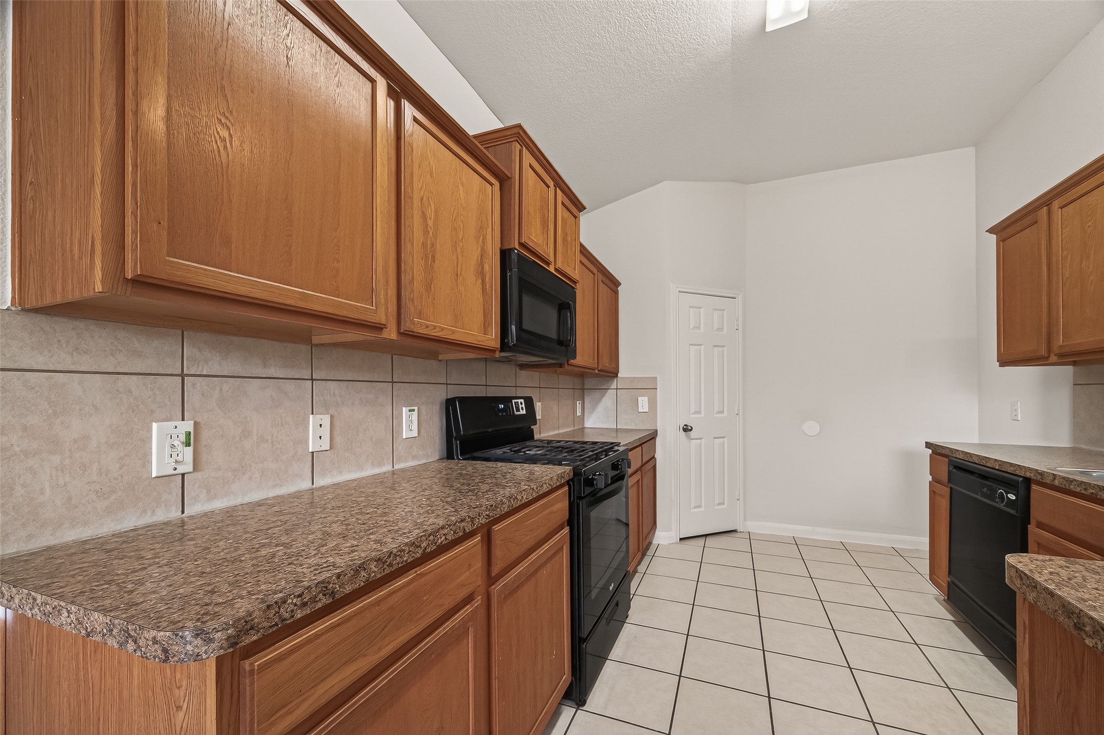 1918 Riane Lane Houston, TX 77049 - Photo 13 of 35 a kitchen with stainless steel appliances granite countertop a sink stove and microwave