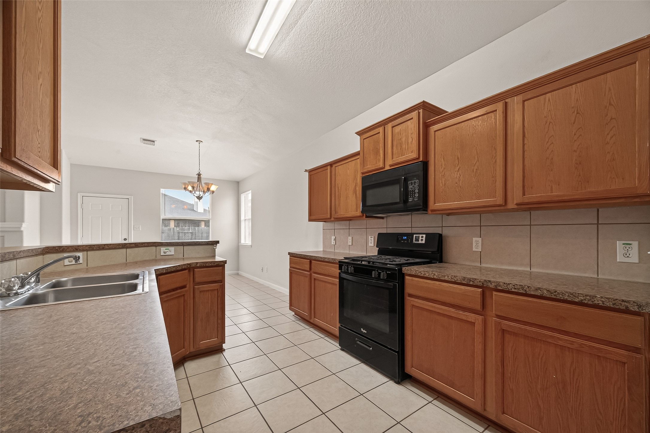 1918 Riane Lane Houston, TX 77049 - Photo 14 of 35 a kitchen with stainless steel appliances granite countertop a stove top oven a sink dishwasher and a microwave oven on the blue kitchen countertops