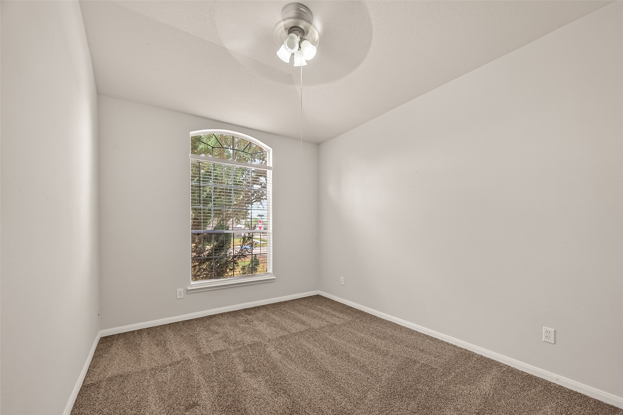 1918 Riane Lane Houston, TX 77049 - Photo 16 of 35 an empty room with a window and ceiling fan