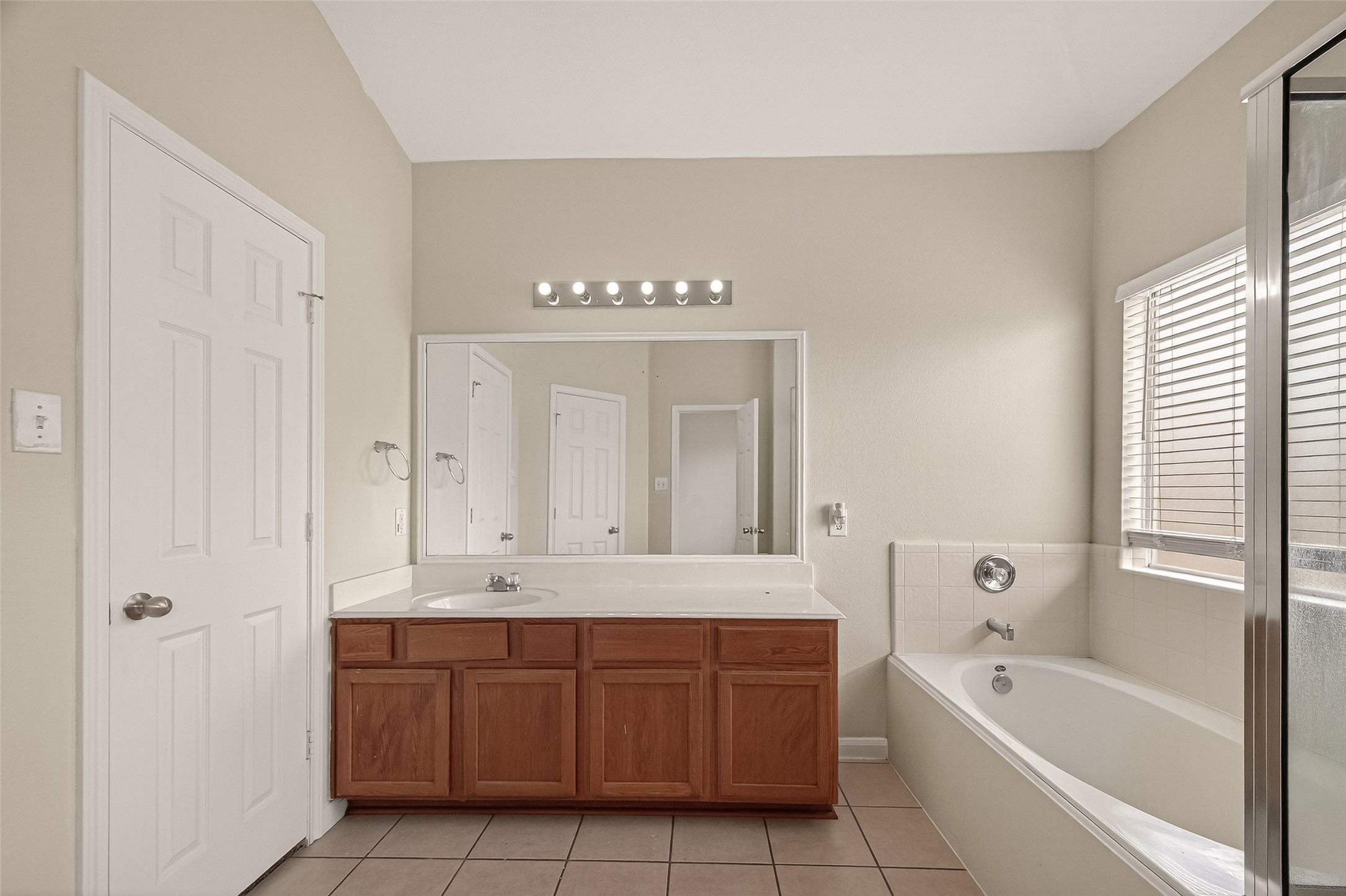 1918 Riane Lane Houston, TX 77049 - Photo 29 of 35 a bathroom with a tub a sink and mirror