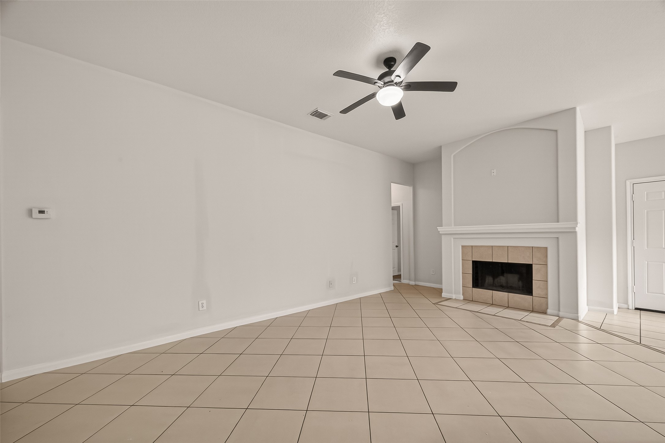 1918 Riane Lane Houston, TX 77049 - Photo 8 of 35 a view of an empty room with chandelier fan and fireplace