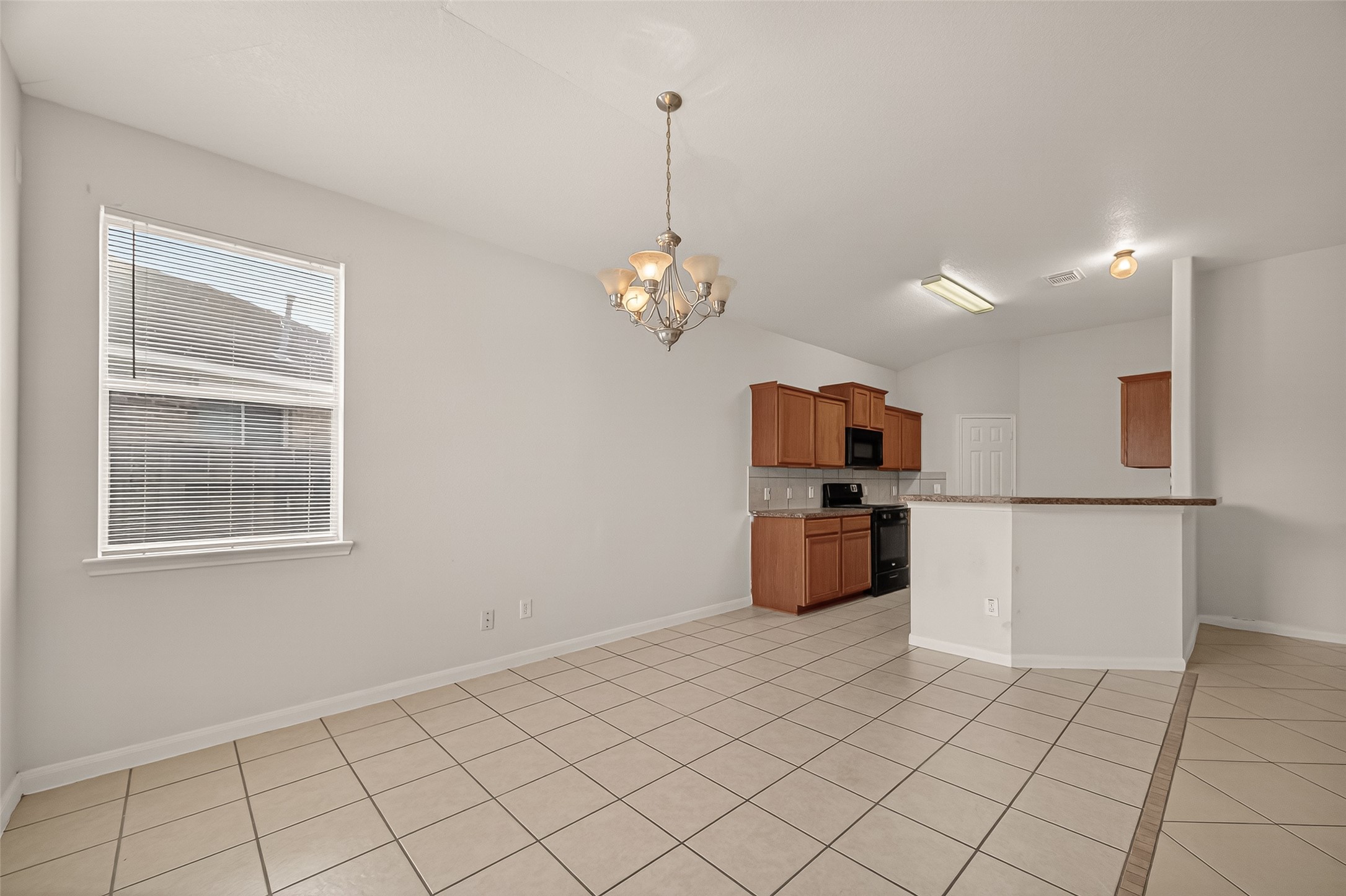 1918 Riane Lane Houston, TX 77049 - Photo 9 of 35 a kitchen with stainless steel appliances a refrigerator and a stove top oven