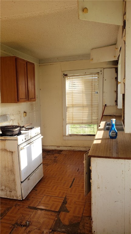 107 North Mott Street Elm Mott, TX 76640 - Photo 13 of 18 a kitchen with a sink stove and cabinets