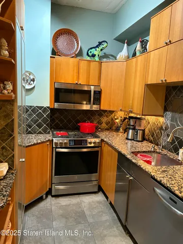 a kitchen with stainless steel appliances granite countertop a stove and a sink