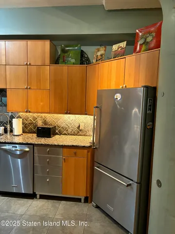 a kitchen with a refrigerator and a sink