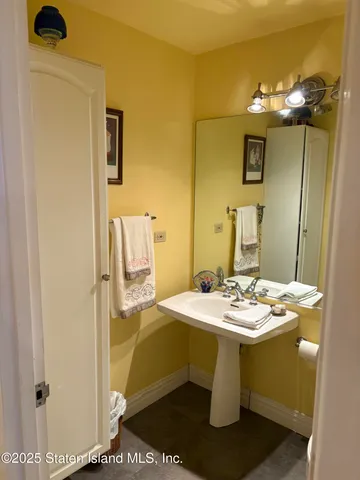 a dining room with a sink and chandelier