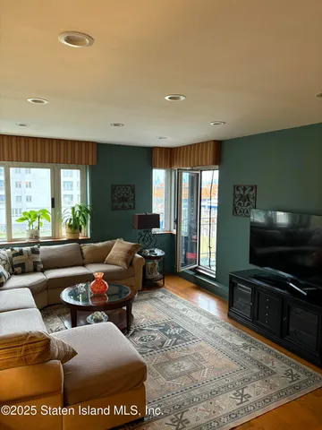 a living room with furniture and a flat screen tv