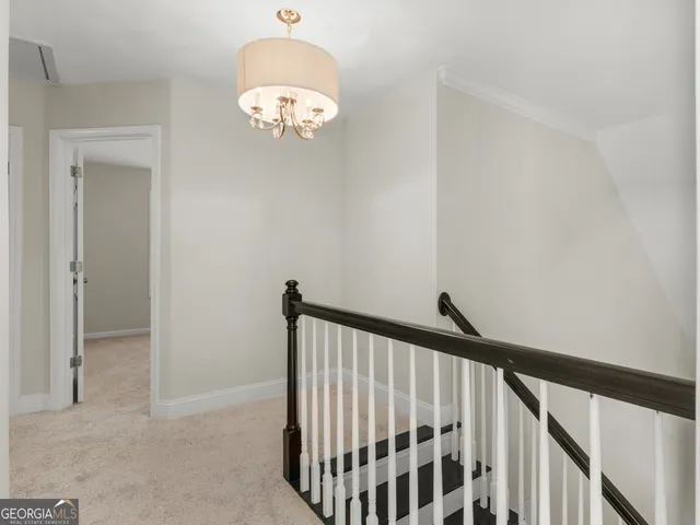 an empty room with windows and ceiling fan