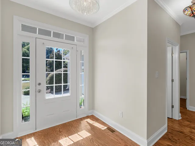a view of empty room with windows and entryway