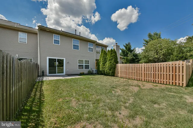 a view of a house with a backyard