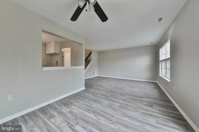 wooden floor in an empty room with a window