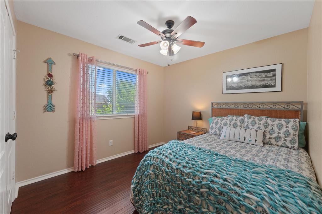 112 Springfield Lane Red Oak, TX 75165 - Photo 22 of 40 Bedroom featuring wood-finish flooring, a ceiling fan with integrated lighting, and a window with blinds