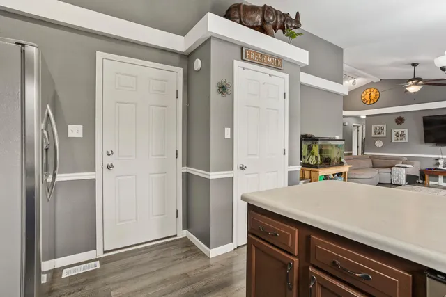 a view of kitchen island with cabinets and wooden floor
